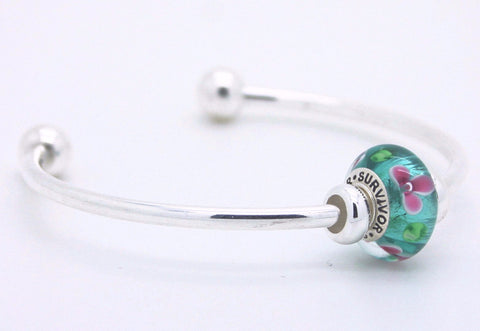 Survivor bead on silver bangle bracelet
